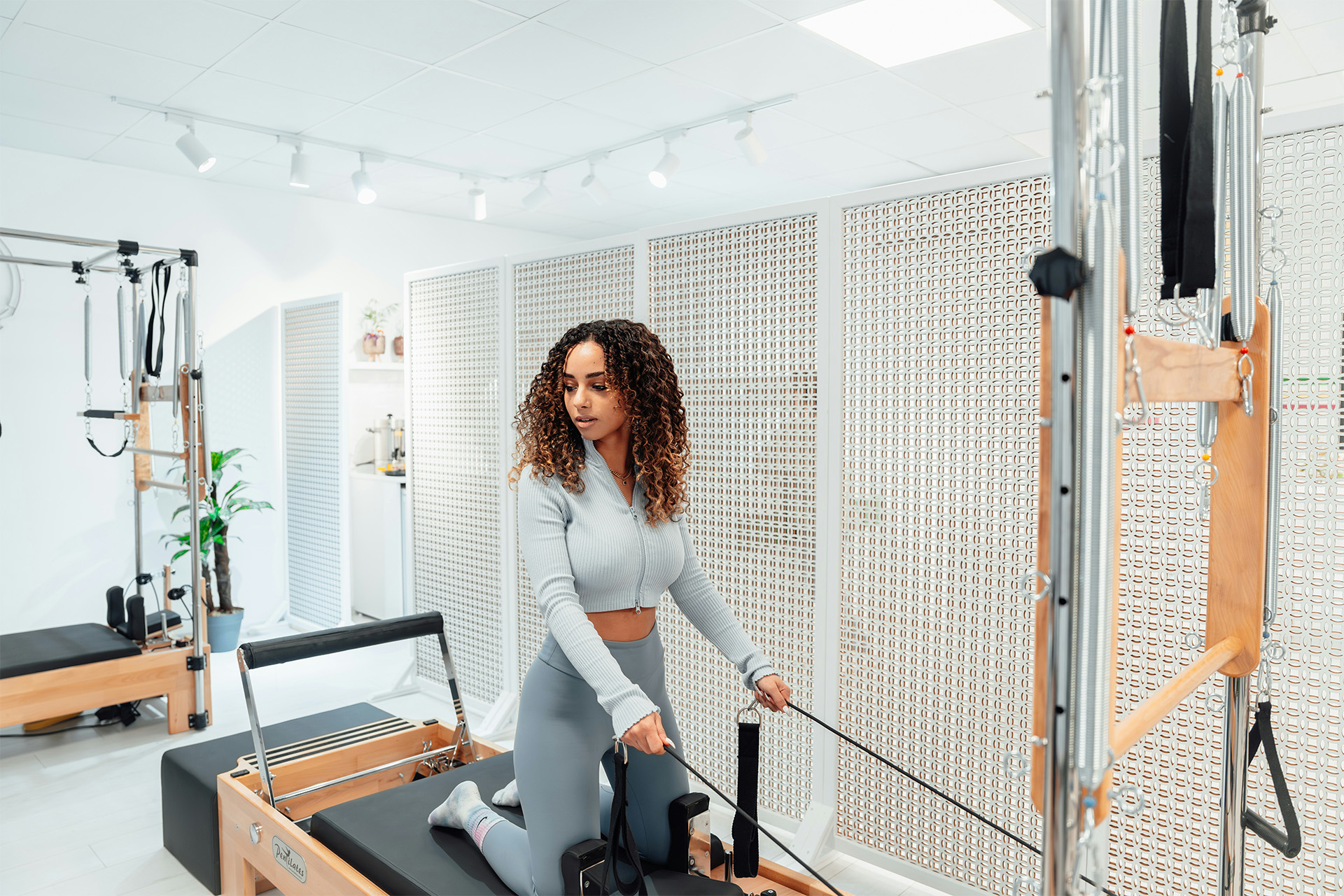 Reformer Pilates session in a bright, calm studio